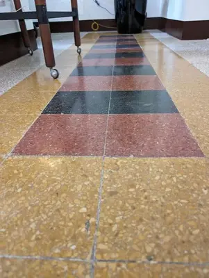 a checkerboard floor in a room with a table at Appartamento della Vittoria in Rome