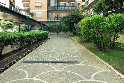 a cobblestone street in front of a large building at A Place Apart in Rome