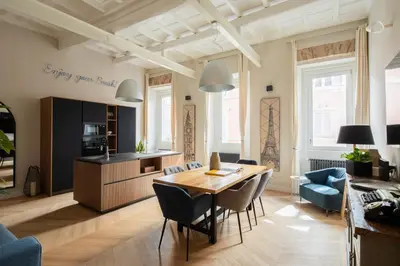 a kitchen and living room with a table and chairs at THE BREAK - Campo Marzio Maison Deluxe in Rome