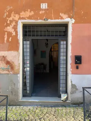 an entrance to a building with an open door at nel cuore di trastevere in Rome