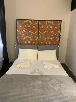 a bed with two slippers on top of it at nel cuore di trastevere in Rome