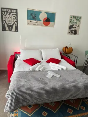 a bedroom with a large bed with red pillows at nel cuore di trastevere in Rome
