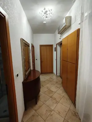 a hallway with a vanity and a mirror in a room at House For You in Rome