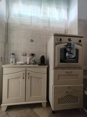 a kitchen with a stove and a counter with a microwave at House For You in Rome