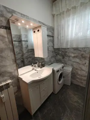 a bathroom with a sink and a washing machine at House For You in Rome