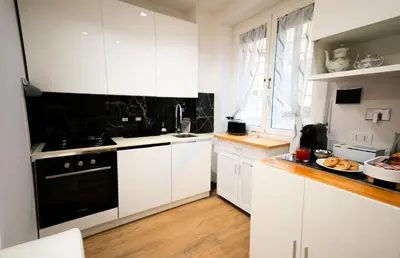 a dining room with white tables and white chairs at MBS Marconi Bridge Suites Guest House in Rome