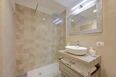 a bathroom with a sink and a mirror at Apartment Vespucci in Rome