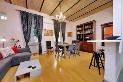 a living room with a couch and a table and chairs at Apartment Vespucci in Rome