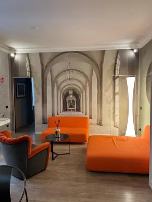 a living room with orange furniture in a building at Colosseum Vibes in Rome