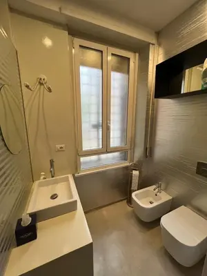 a bathroom with a sink and a toilet and a mirror at Colosseum Vibes in Rome