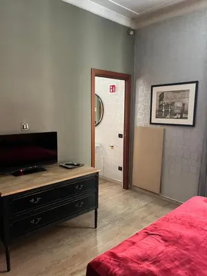 a bedroom with a bed and a dresser and a mirror at Colosseum Vibes in Rome