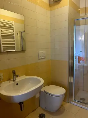 a bathroom with a sink and a toilet and a shower at Dina Suite Rome in Rome
