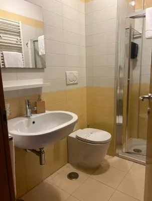 a bathroom with a sink and a toilet and a shower at Dina Suite Rome in Rome