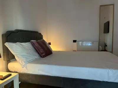 a bed with a pillow on it in a room at Dina Suite Rome in Rome