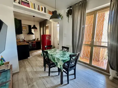 a kitchen and dining room with a table and chairs at Cozy Apartment with Metro Link to the Colosseum in Rome