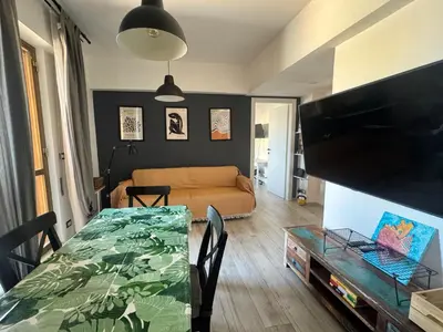 a living room with a table and a couch at Cozy Apartment with Metro Link to the Colosseum in Rome