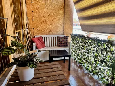 a chair and a table on a balcony at Cozy Apartment with Metro Link to the Colosseum in Rome