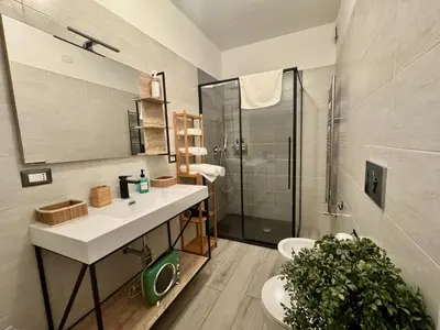 a bathroom with a sink and a shower and a toilet at Cozy Apartment with Metro Link to the Colosseum in Rome