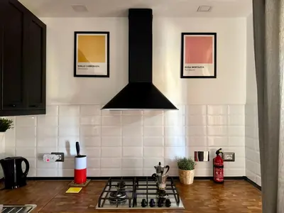 a kitchen with a stove top oven in a kitchen at Cozy Apartment with Metro Link to the Colosseum in Rome