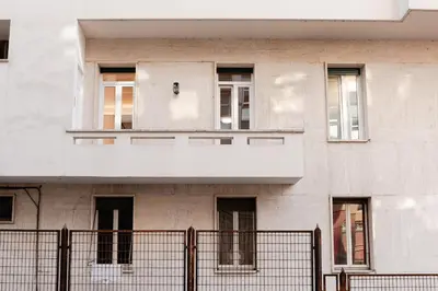 a door to a building with green rails in front at Casa Vacanze Roma in Rome
