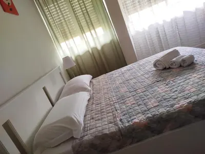 a bedroom with a bed with towels on it at Dylan Apartment in Rome