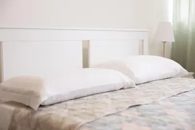 a bed with two pillows on top of it at Dylan Apartment in Rome