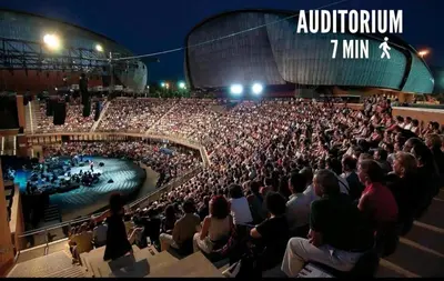 a large crowd of people in an auditorium watching a show at Dylan Apartment in Rome
