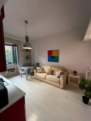 a living room with a couch and a table at Procida's House by ACS HOLIDAYS in Rome