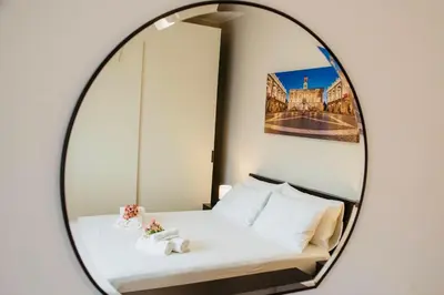 a bedroom with a bed in a mirror at Domusky Attico - 8 piano in Rome