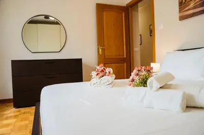 a bedroom with a white bed with flowers on it at Domusky Attico - 8 piano in Rome