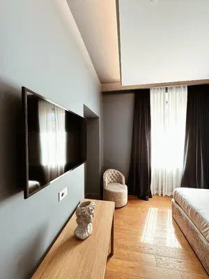 a living room with a tv and a table at Residenza Imperiale - Luxury Guest House in Rome