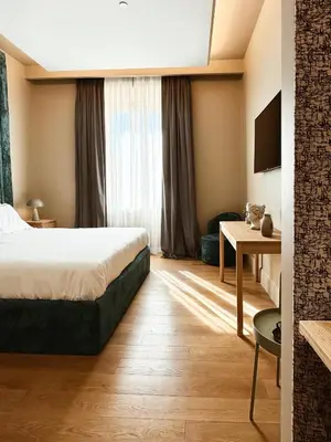 a hotel room with a bed and a desk at Residenza Imperiale - Luxury Guest House in Rome