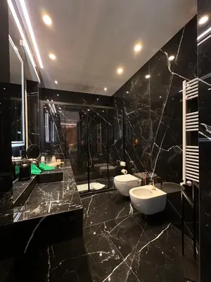 a black bathroom with two sinks and two toilets at Suite dolce vita - san pietro in Rome