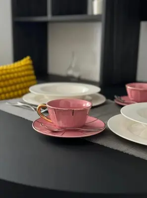 a table with pink cups and plates on it at Suite dolce vita - san pietro in Rome