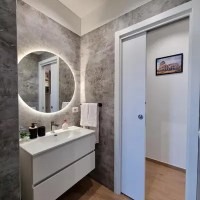 a bathroom with a sink and a mirror at Suite Station Tiburtina in Rome