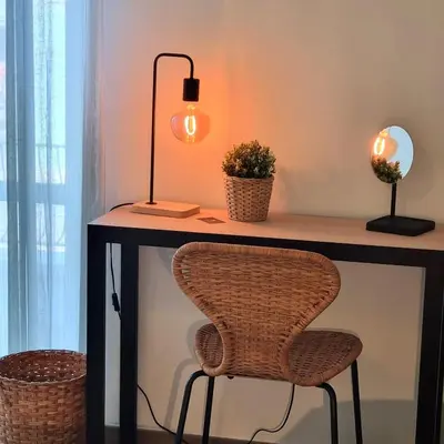 a desk with a chair and a lamp on it at Suite Station Tiburtina in Rome