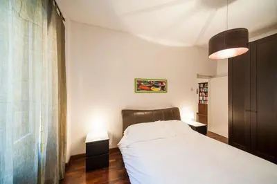 a bedroom with a white bed and a large window at Great Apartment in great Location in Rome