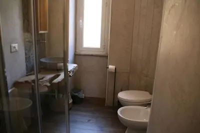 a bathroom with a toilet and a sink and a window at Great Apartment in great Location in Rome