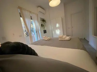 a bedroom with two beds with towels on them at Suite Mario - Colosseo in Rome