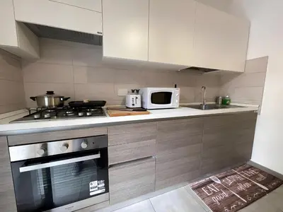a kitchen with a stove and a microwave at Suite Mario - Colosseo in Rome