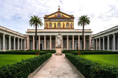 a building with a statue in the middle of a garden at Suite Mario - Colosseo in Rome