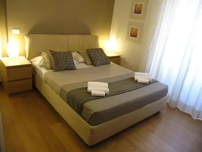 a bedroom with a large bed with two night stands at Matteo al Vaticano Vicino Metro in Rome