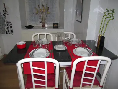 a table with a red table cloth and white plates and glasses at Matteo al Vaticano Vicino Metro in Rome