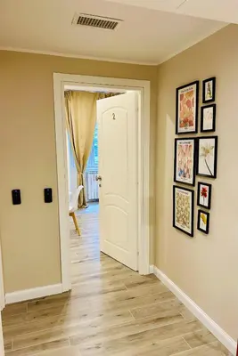 a hallway with a white door and pictures on the wall at Domus Altino in Rome