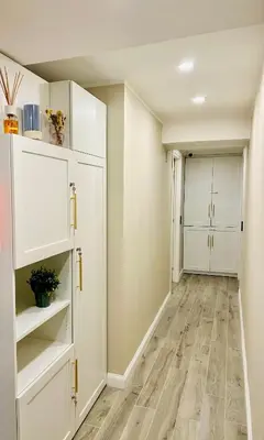 a hallway with white cabinets and a hardwood floor at Domus Altino in Rome
