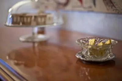 a glass bowl on a table with a plate of food at La Casetta di Zio Mario in Rome