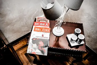 a table with a book and a lamp on a table at La Casetta di Zio Mario in Rome