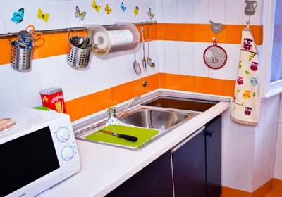 a small kitchen with a sink and a microwave at La Casetta di Zio Mario in Rome