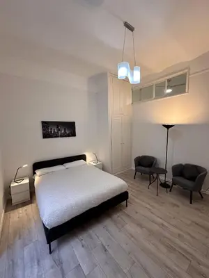 a bedroom with two chairs and a bed and a desk at PGL San Lorenzo in Rome