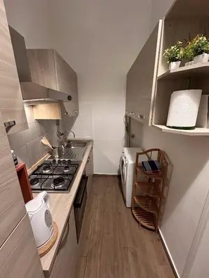 a white bathroom with a toilet and a sink at PGL San Lorenzo in Rome